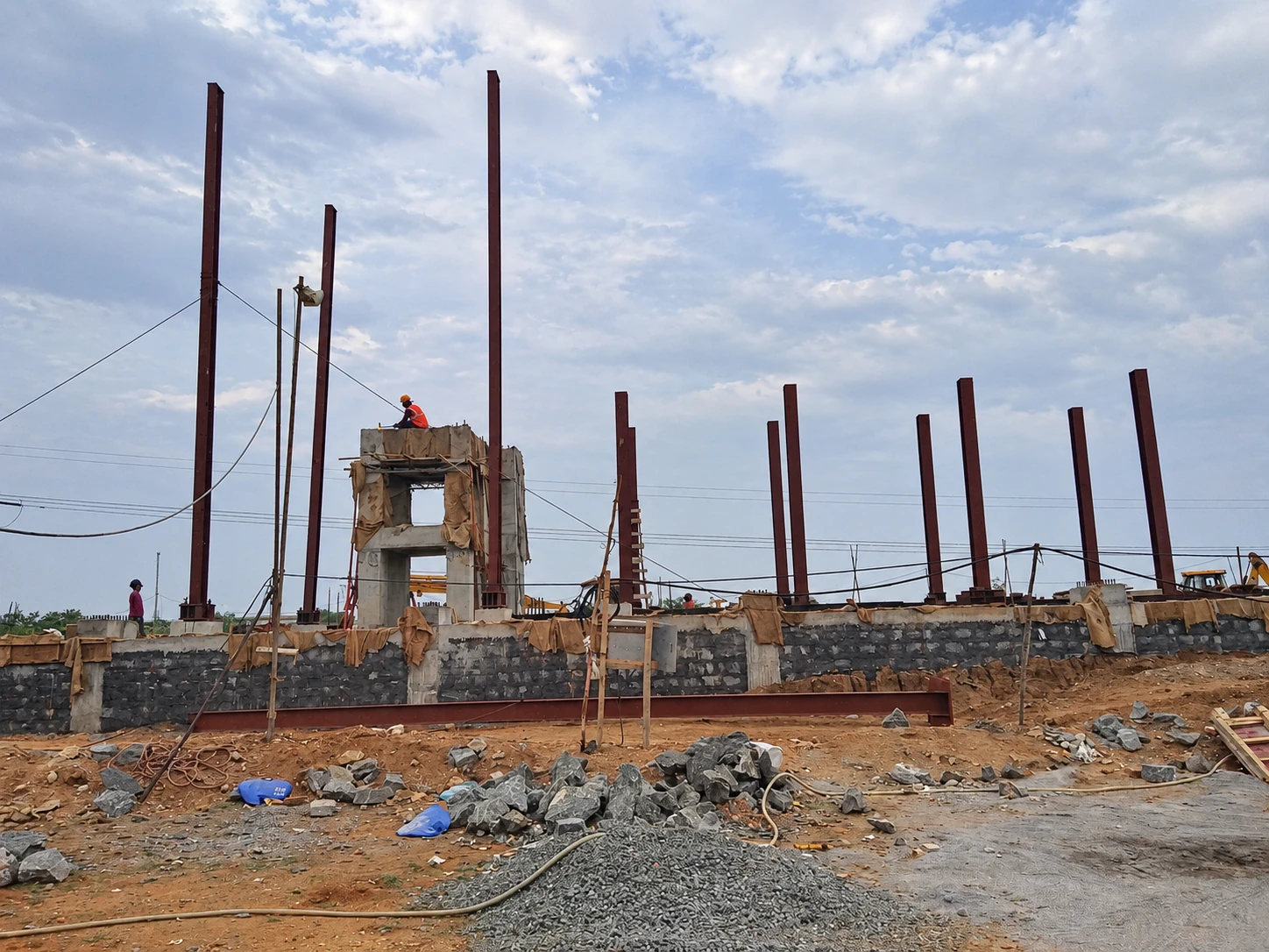 Steel columns rising over the JS Auto Cast Foundry construction site.